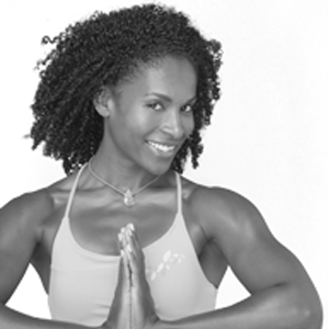 Leslie Salmon Jones looks at the camera while striking a yoga pose.