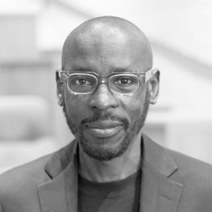 Headshot of Mario Gooden. He is wearing glasses and a suit jacket.