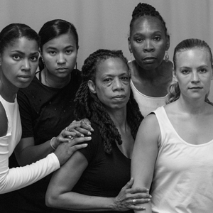 Nailah Randall-Bellinger poses with four dancers. All of them are looking at the camera.
