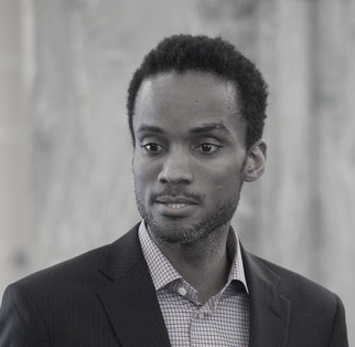 Headshot of Sekou Cooke. He is looking away from the camera and wearing a shirt and suit jacket.