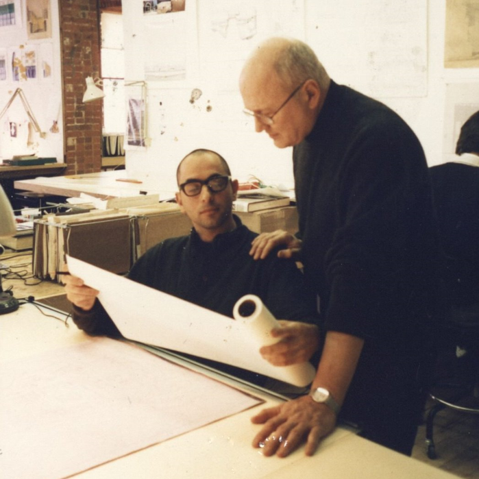 colored image of jorge silvetti and nader tehrani going over architectural drawings