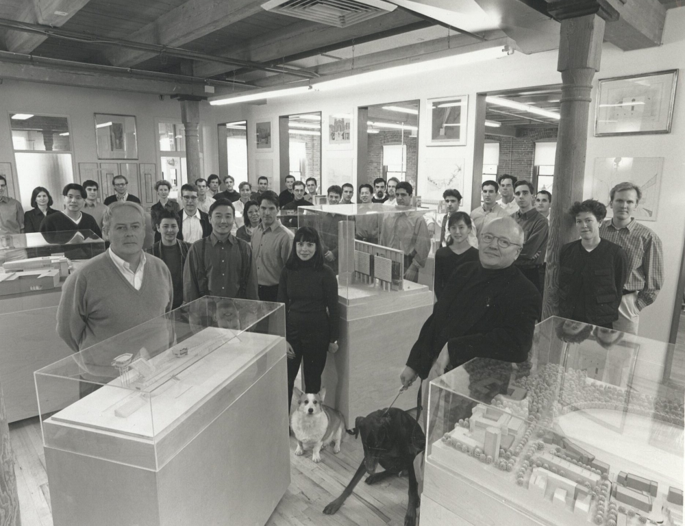 Jorge Silvetti and Rodolfo Machado standing in front of their Machado & Silvetti Associates with Gomez and Otto, the corgi and doberman pinscher.
