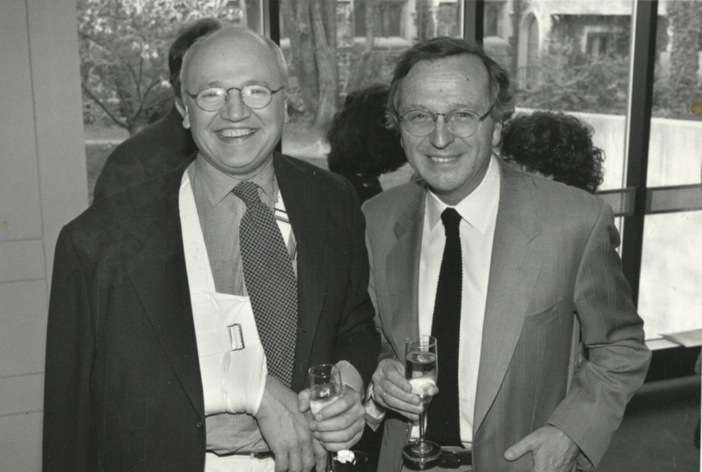 Jorge Silvetti and a man smile at the camera at a reception.