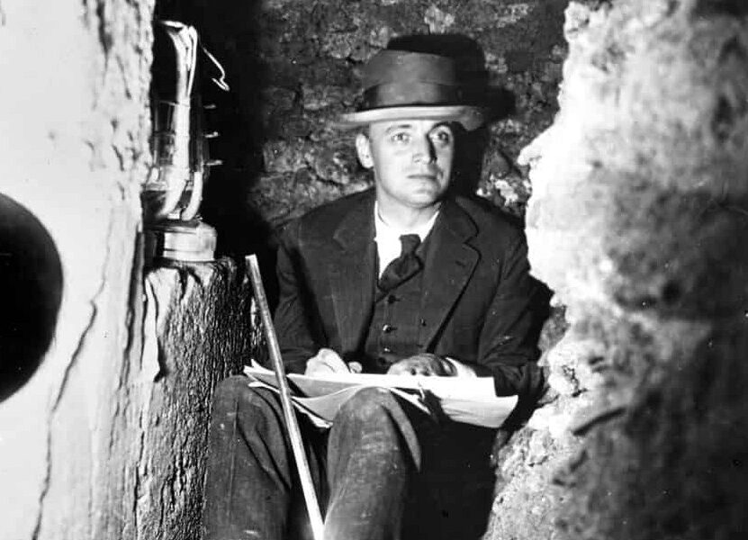 Photograph of Kenneth Conant in an excavation trench at Cluny.