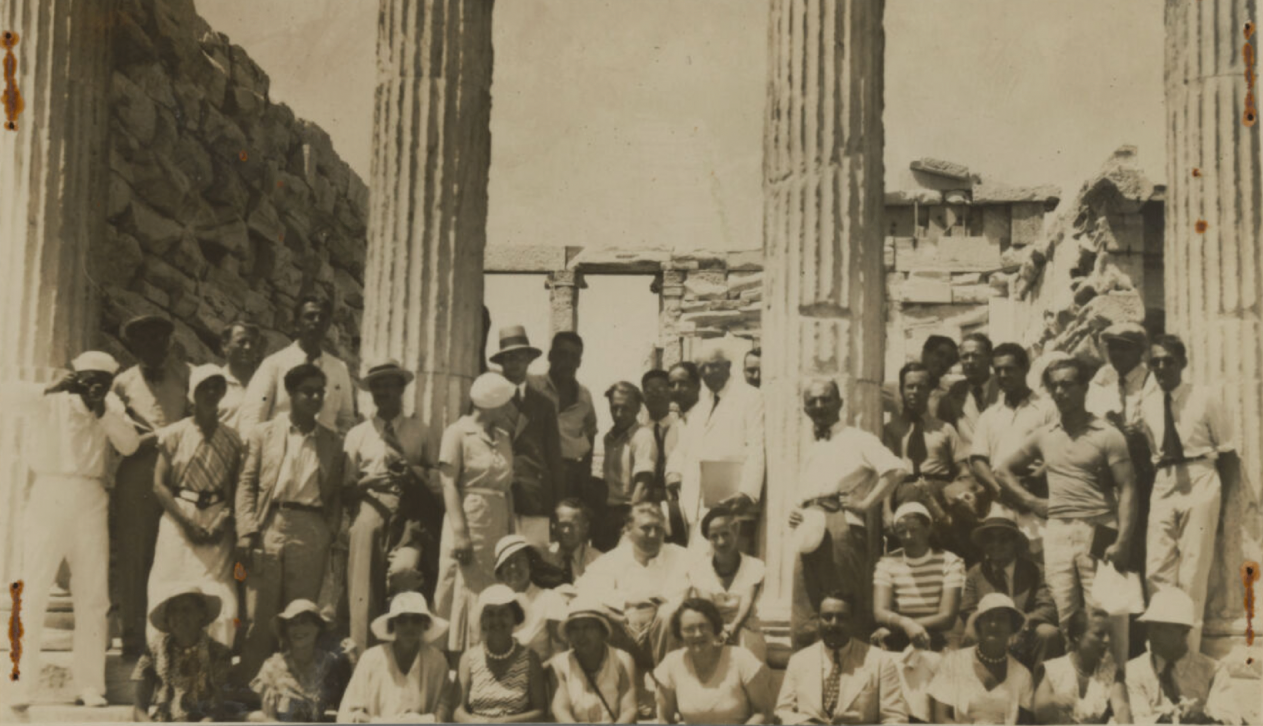Participants in front of two columns on a site.