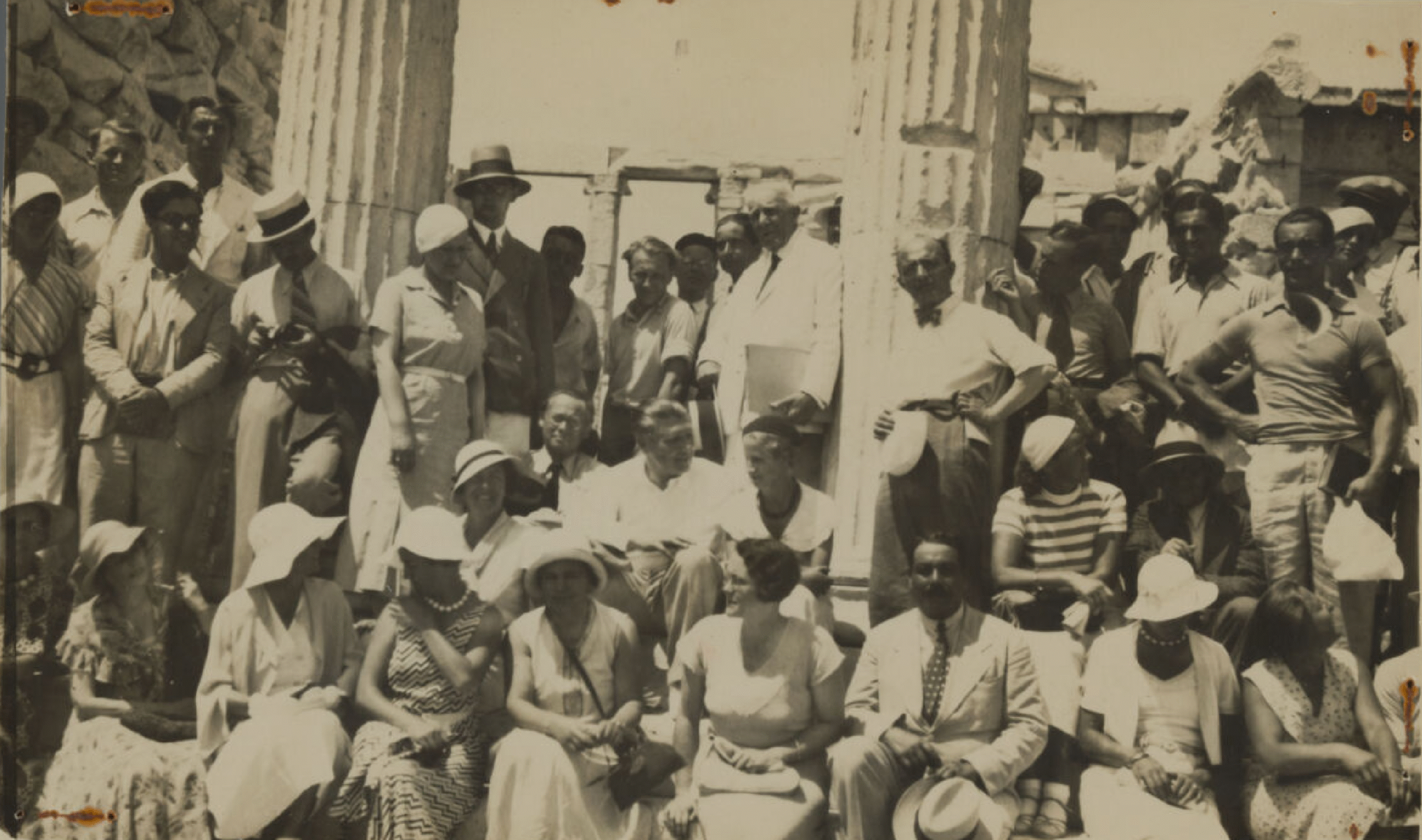 Participants in front of two columns on a site.